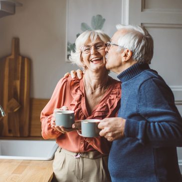 A caregiver checking in warmly with a senior client at home