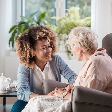 An exercise professional supporting a senior through a wellness activity